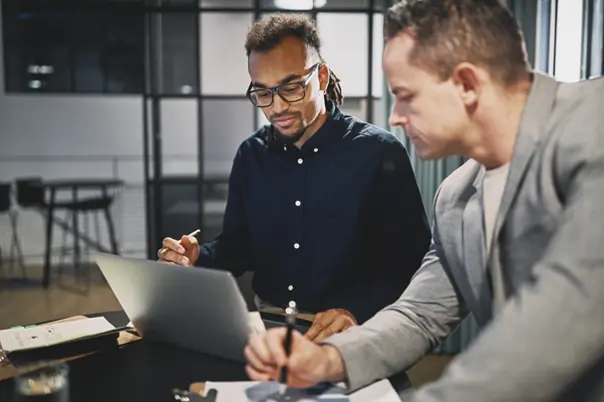 Two Men working on a laptop